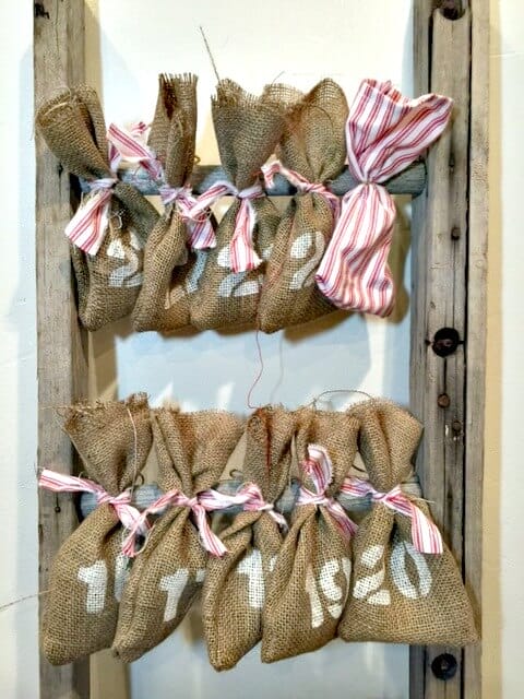 Make this super easy reusable advent calendar with a ladder and some burlap bags! So adorable, the kids will love it!