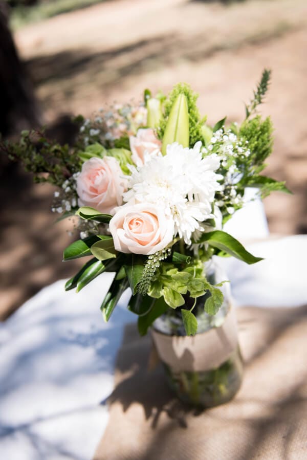 Simple flower arrangements for an outdoor woodland wedding. That blush rose is perfection!