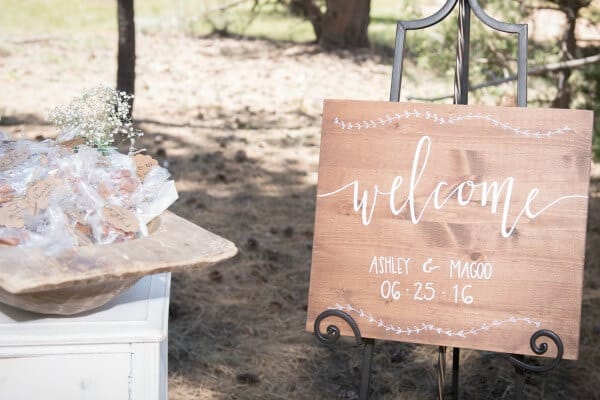 Love this welcome sign for a wedding. The rustic combined with the white is perfect!