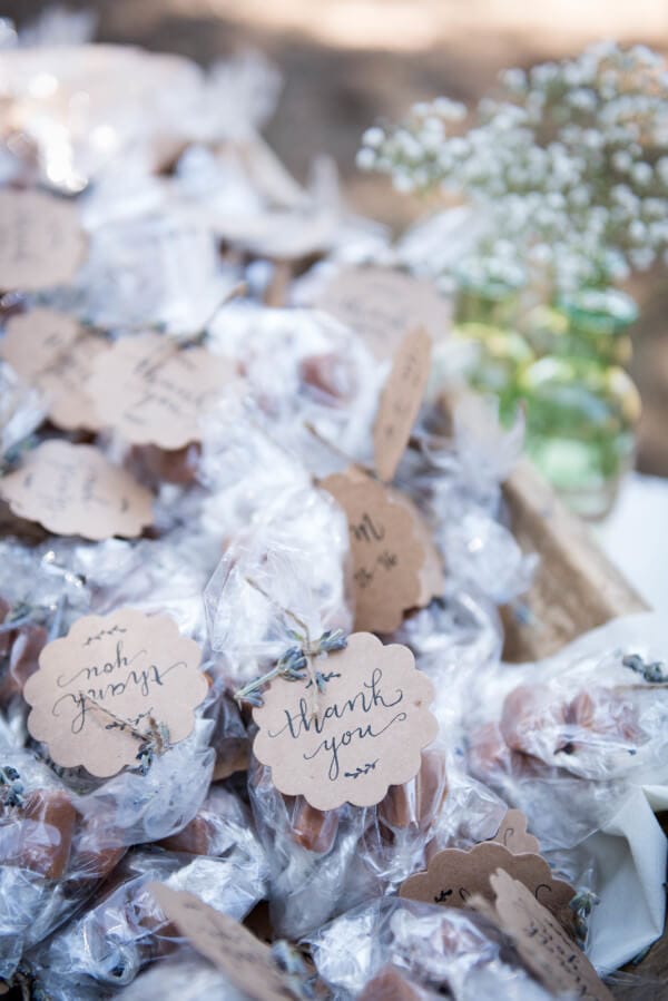 Handwritten thank you cards on party favors for this outdoor woodland wedding.