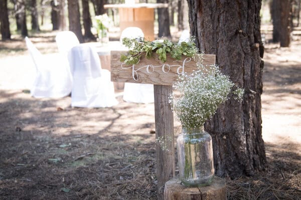 Simple dinging atmosphere for an outdoor woodland wedding. Old wire spools as tables, white chair covers and babies breath. You just can't go wrong.