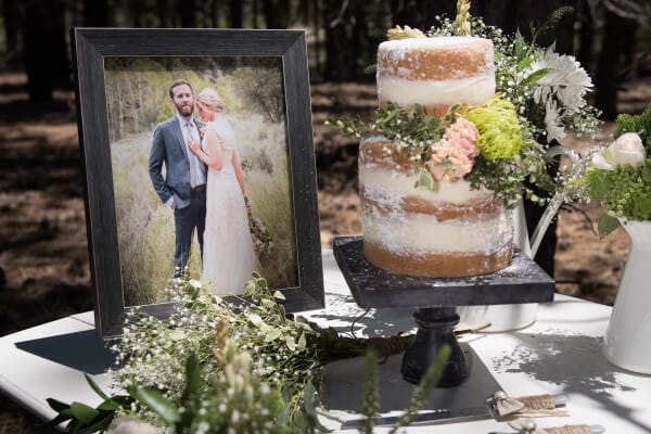 Simple and elegant wedding cake for an outdoor woodland themed wedding. Love the blush colored flowers and babies breath. The raw look of the cake is so cool!