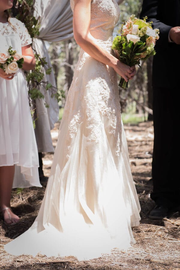 Here comes the bride. Beautiful soft blush wedding dress for her outdoor woodland themed wedding.