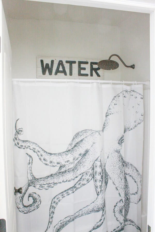This reclaimed water sign is the perfect addition to this budget friendly bathroom makeover! | Twelveonmain.com