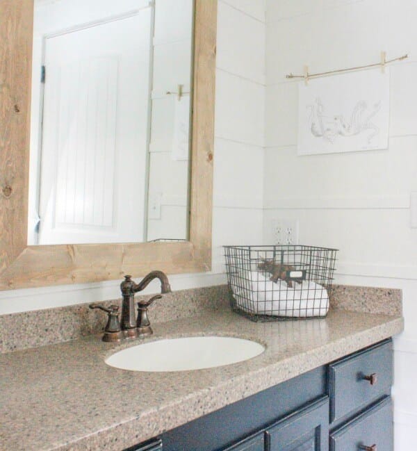 Customizing this mirror was a big part of this budget friendly bathroom makeover.