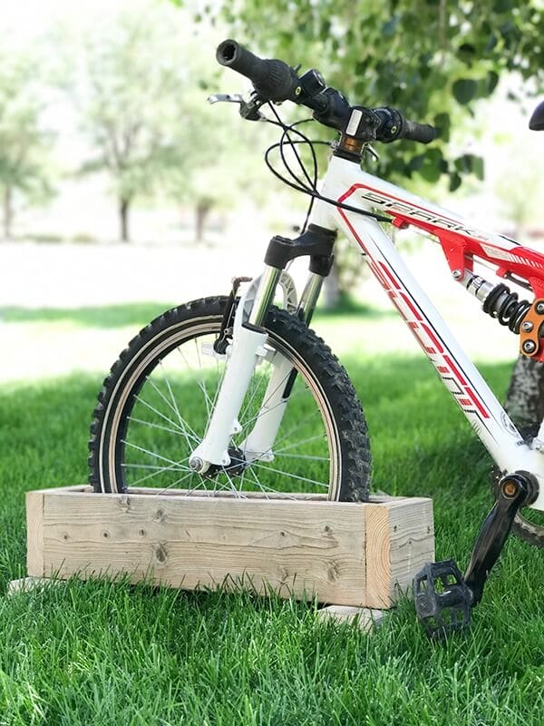 Get your kids bikes off the grass with this easy DIY bike rack! So easy to make, I made it in 10 minutes!