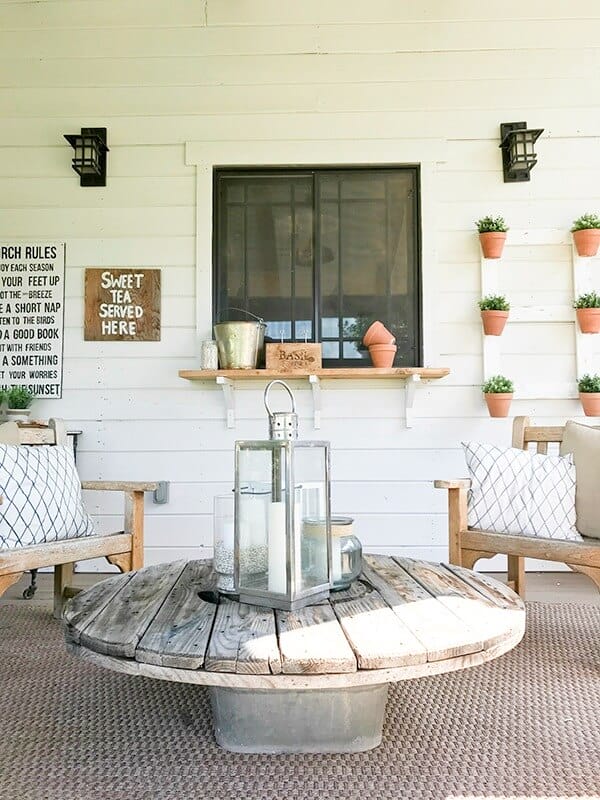 I love this easy salvaged coffee table! Its made from a wire spool and galvanized tub! Goes so well with the farmhouse summer porch decor!