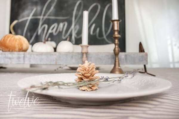 Simple farmhouse fall dining room features....ticking stripe fabric, white pumpkins, old books, and chalkboard art.