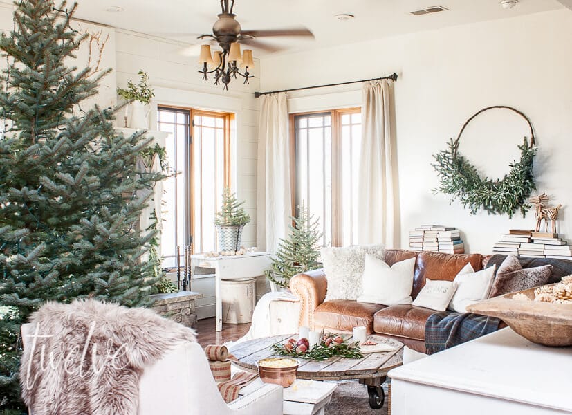 When you take a fantastic rug, lots of evergreen, fur rugs, rustic wood, and white accents, you get my cozy and simple farmhouse Christmas living room decor