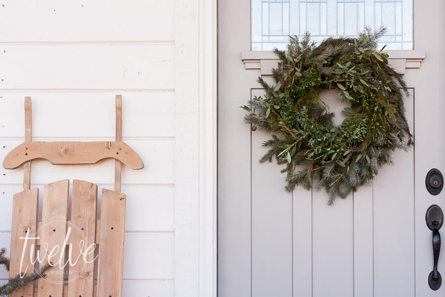 Fresh blue spruce trees, simple natural farmhouse Christmas decor, are all you need to create a beautiful farmhouse Christmas porch and entry.