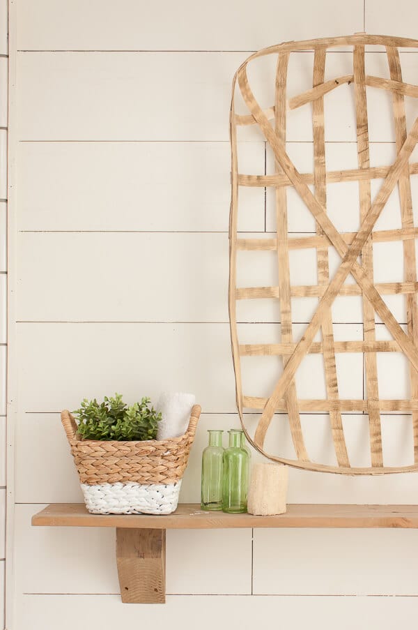 Rustic wood shelves, tobacco basket, shiplap and subway tile in the master bathroom. So very farmhouse style! 
