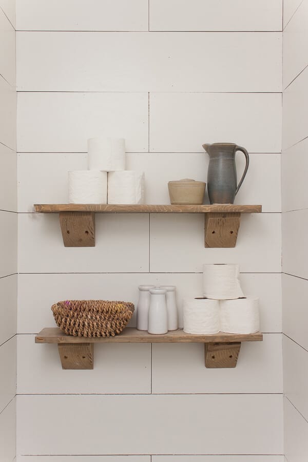Love these rustic wood shelves in the water closet! 