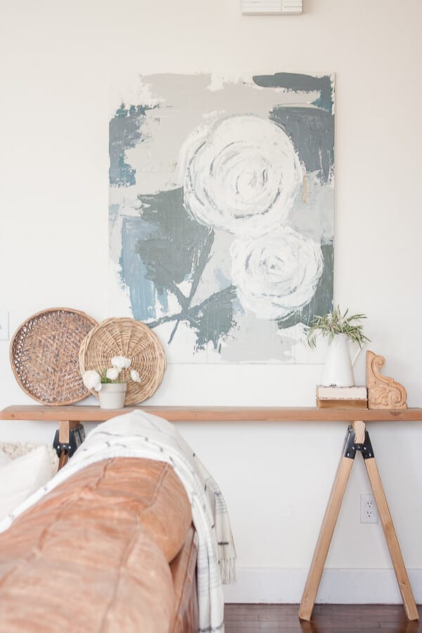 I love the combination of the farmhouse artwork, and the rustic wooden saw horse table! Full tutorial found here!