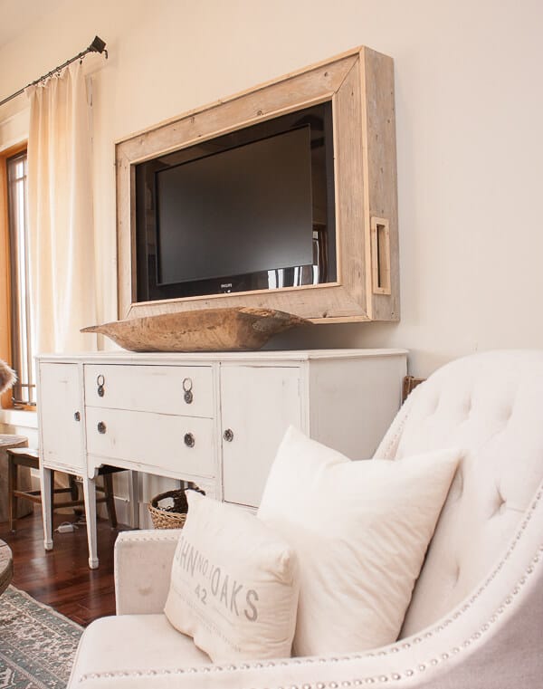 This DIY TV frame has transformed this whole room! No more ugly television and its now a focal point!