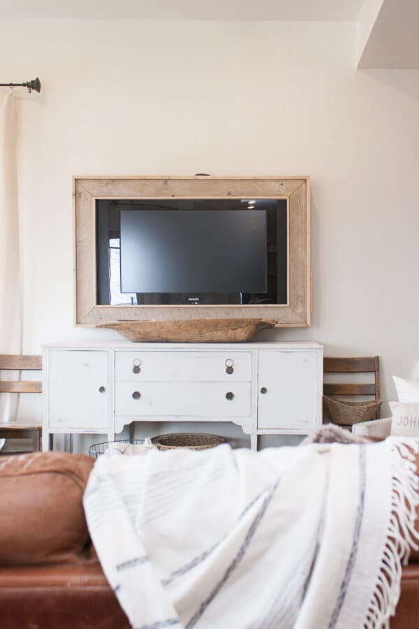 Want to hide that ugly television?  Make your own TV frame with this simple DIY tutorial and create a stylish look for your home.