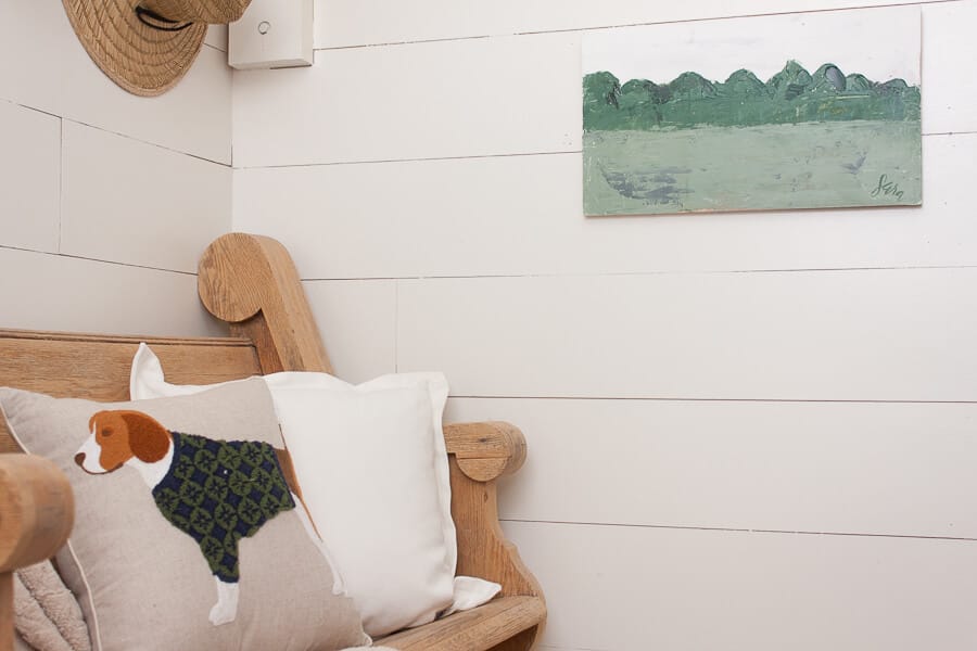 Shiplap, a vintage church pew, straw hats, an adorable dog pillow and a custom piece of artwork makes this spring entryway decor stand out! #TwelveOnMain #springdecor