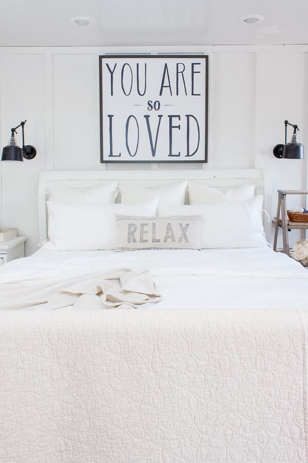Cozy master bedroom with white linen bedding from IKEA and a simple solution to keeping bed pillows looking like new!