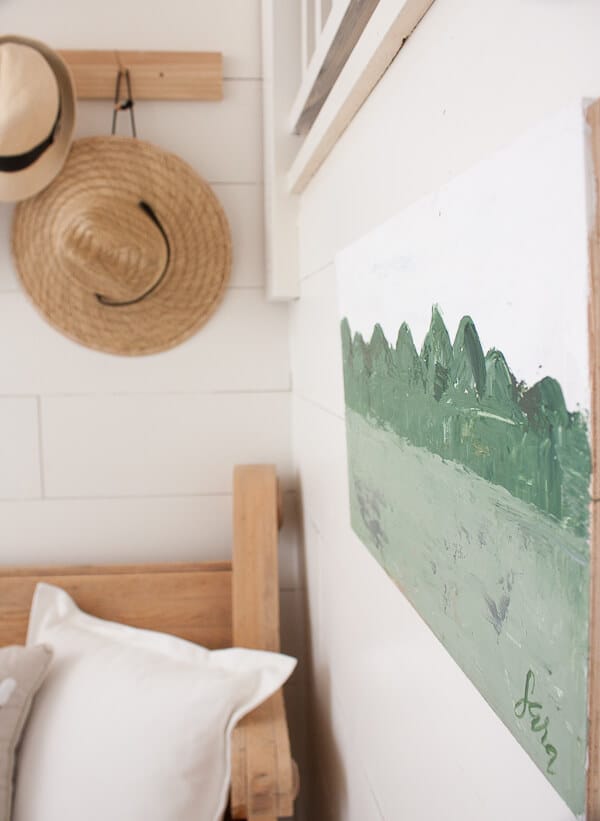 Small farmhouse artwork in the entryway. Vibrant greens and whites contrast each other beautifully