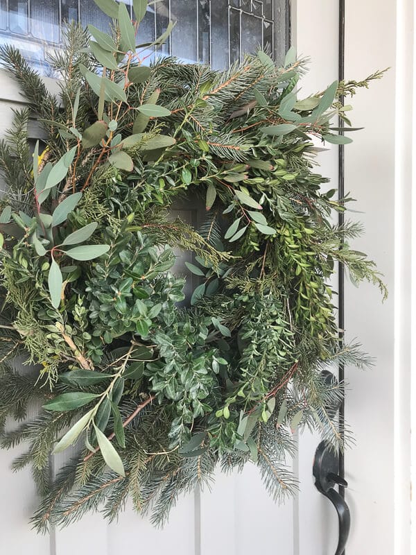 Woodland style fresh Christmas wreath made with pine bough cuttings, olive branches, eucalyptus, and boxwood!