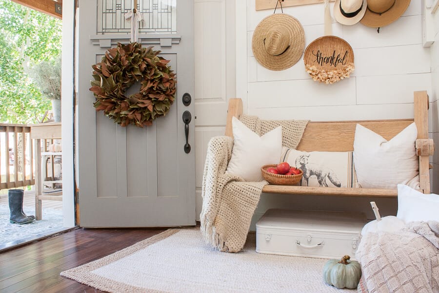Cozy and serene fall decor in the entryway, full of farmhouse decor, raw wood, and so much more!