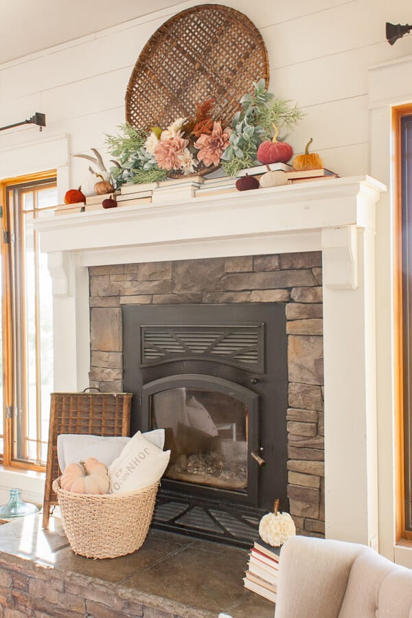 Fall mantel decor with flowers, pumpkins and books!