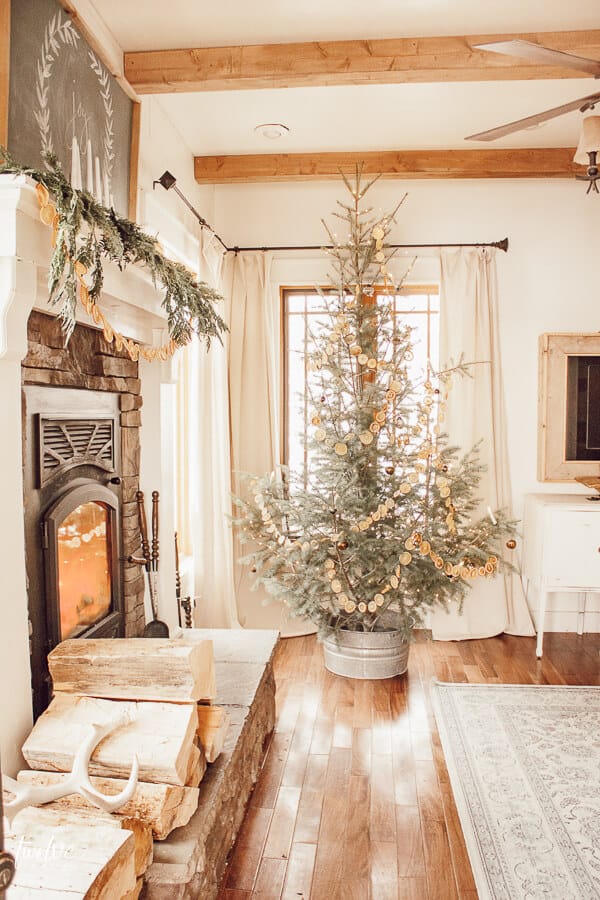 Scandinavian Christmas tree, dried orange garland, use of sheepskin, white decor accents, lots of wood, and those wood beams!