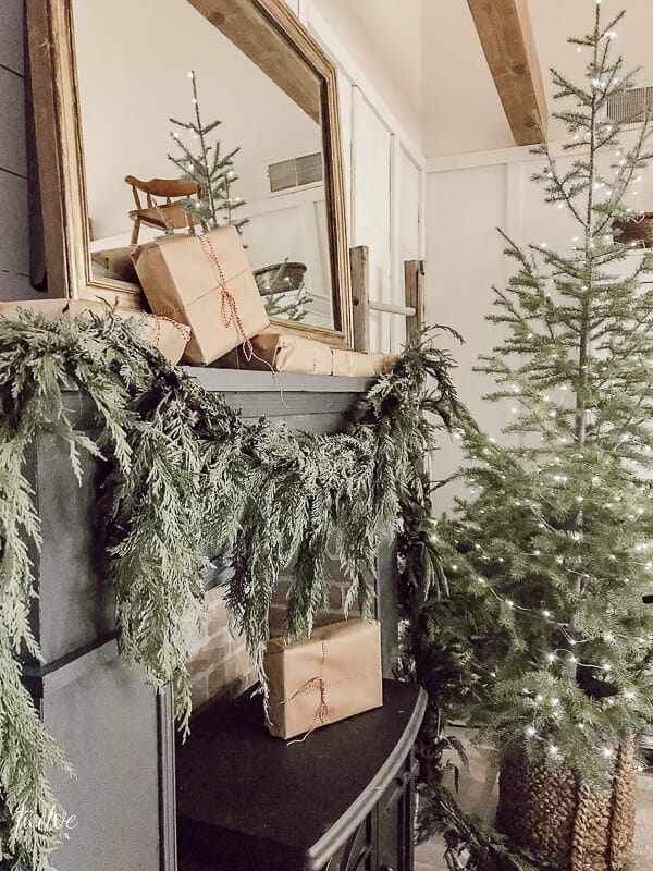 Fresh greenery, simple wrapped Christmas presents, and oodles of farmhouse Christmas bedroom decor.