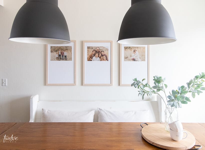Modern farmhouse dining room design touches including custom framed artwork and modern IKEA Hektar lights!