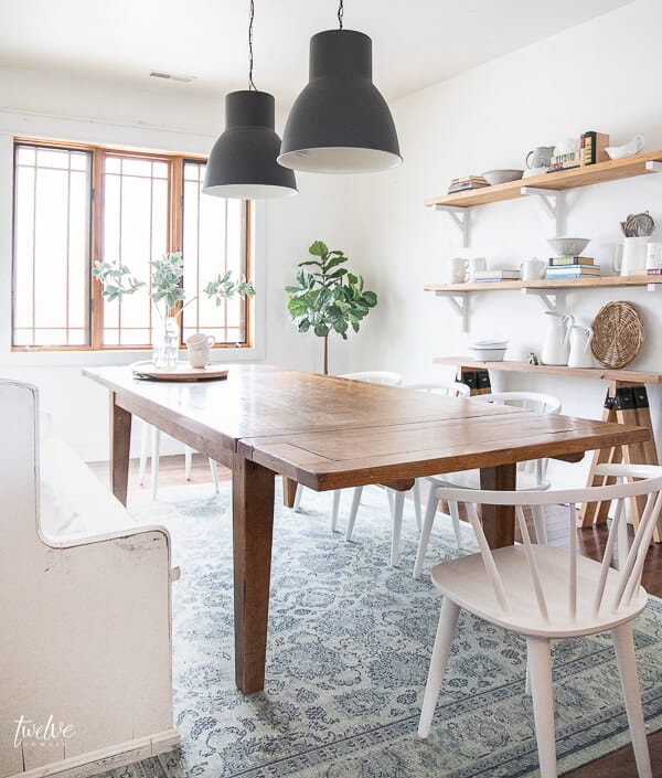 Ikea Hektar lights, rustic wood shelves, white spindle chairs and so much more in this modern farmhouse dining room design