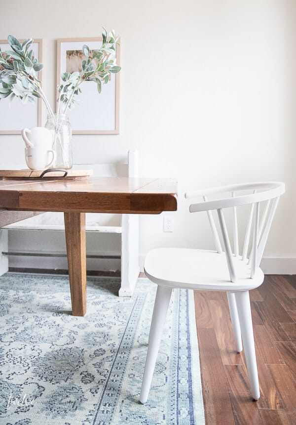 Amazing simple white spindle dining chairs are perfect with this rustic farmhouse table.