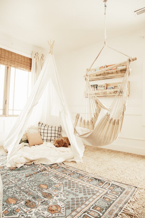 Boho style reading nook with a teepee and a hanging chair!