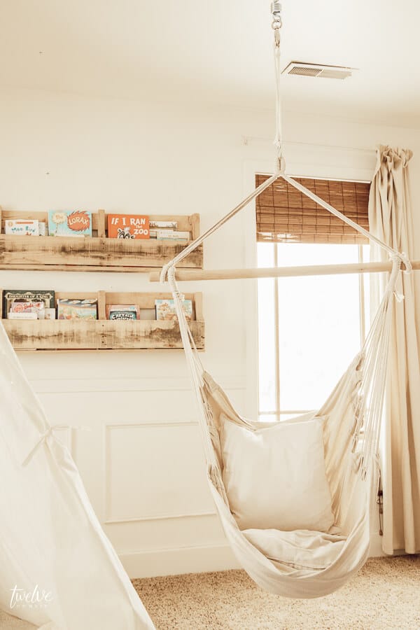 Cozy boho style girls reading nook, complete with a teepee and a hanging chair!