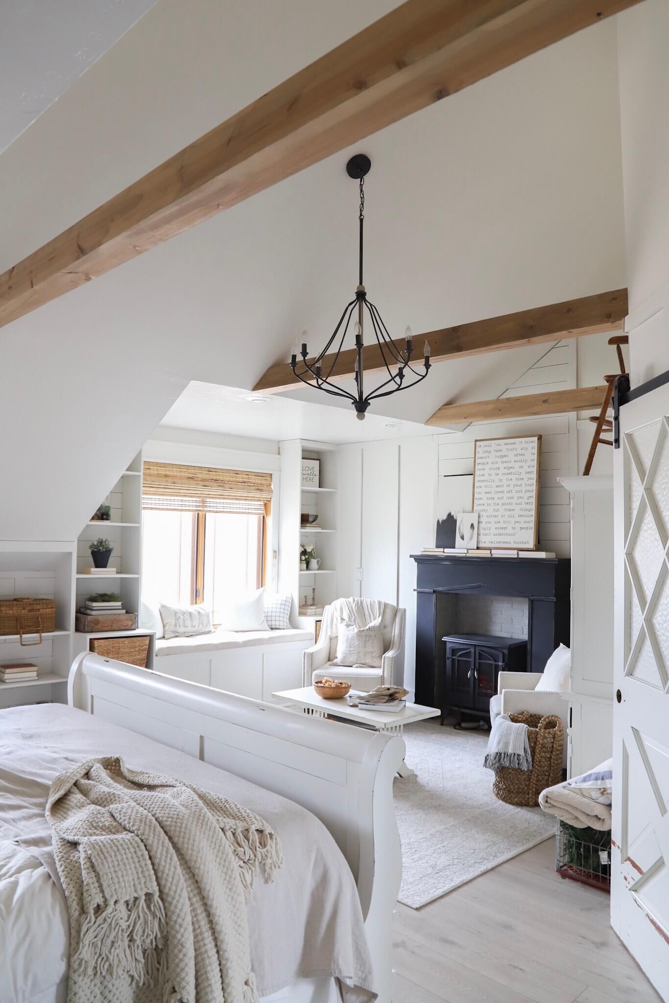 Gorgeous master bedroom retreat with exposed beams, a farmhouse style fireplace and so much more!