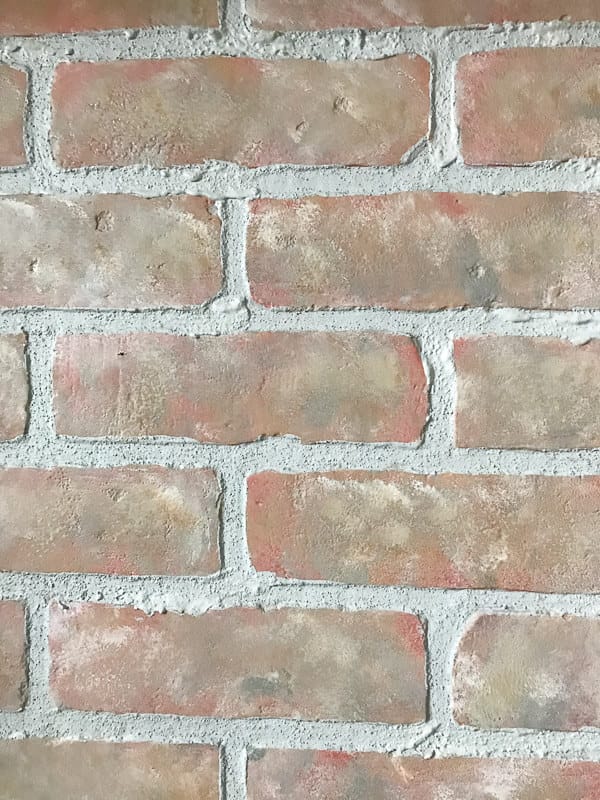 How to turn faux brick panels into stylish home decor that looks like its been there for years.