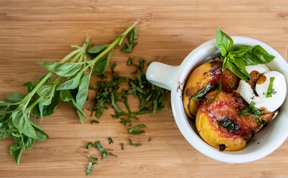 Try this decadent roasted peach dessert with homemade cheesecake mousse, basil, and a balsamic reduction. Its the perfect party treat or just for yourself on a Friday night!