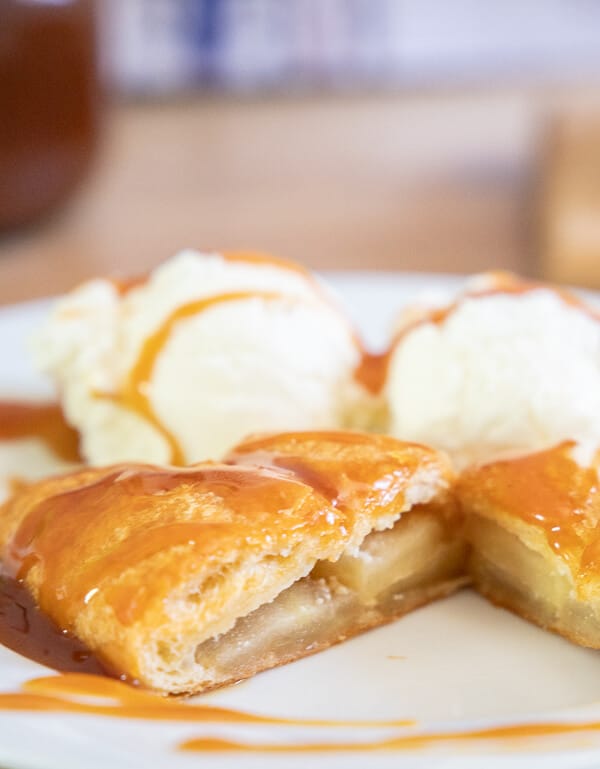 This is a great sweet treat to make for your family! With spiced apples, sweet cheesecake filling all wrapped up in crescent rolls! Top it with my favorite homemade caramel sauce recipe and some vanilla ice cream and you have the most decadent dessert in no time!