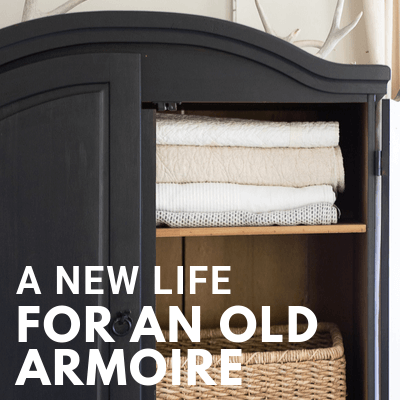 Black armoire in the living room. Stylish and functional, creating storage that is sorely needed. How I took an unloved cheap piece of broken furniture and transformed it.