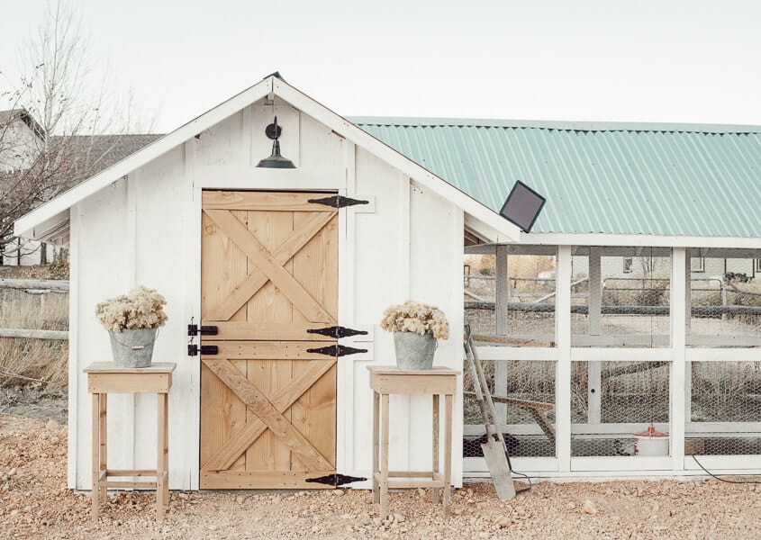 Gorgeous chicken coop design ideas, complete with tin roof, board and batten, a dutch door and stylish outdoor solar lights!