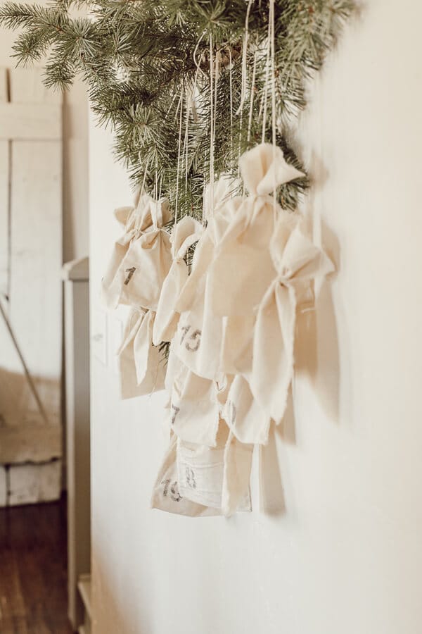Simple Christmas decor with muslin bags stenciled with the numbers of the month of December!