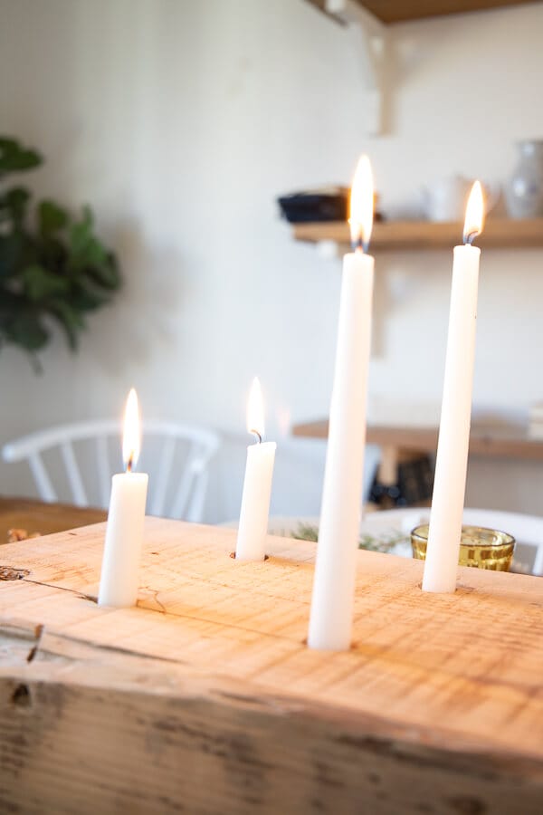 Under the glow of a cluster of candles this Thanksgiving tablescape is truly cozy and inviting!