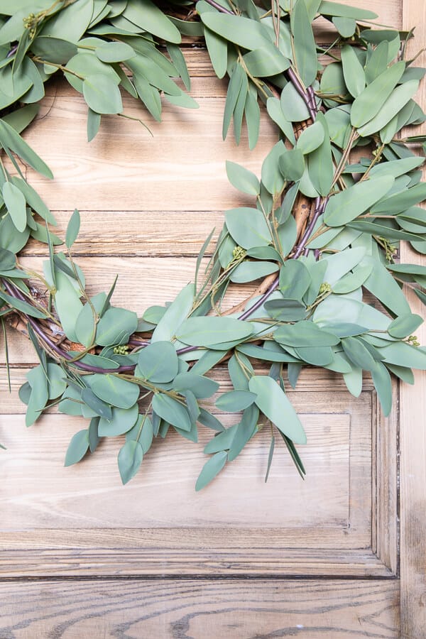 How to make a faux eucalyptus wreath with 3 items, and in less than 5 minutes! Its also easily changeable using floral wire, you can change this wreath out seasonally and make it over as often as you want!