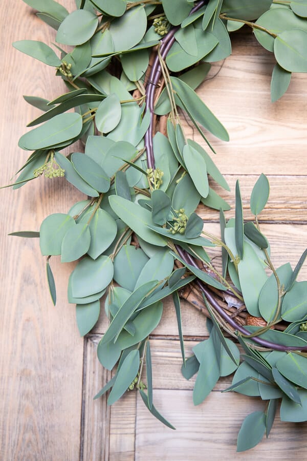 Make this gorgeous faux eucalyptus wreath for spring, summer or all year long. This wreath takes less than 10 minutes to make and looks amazing! The best part is you can disassemble and change it out for different seasons. It is a great budget friendly way to have gorgeous wreaths in your home! 10 minutes.