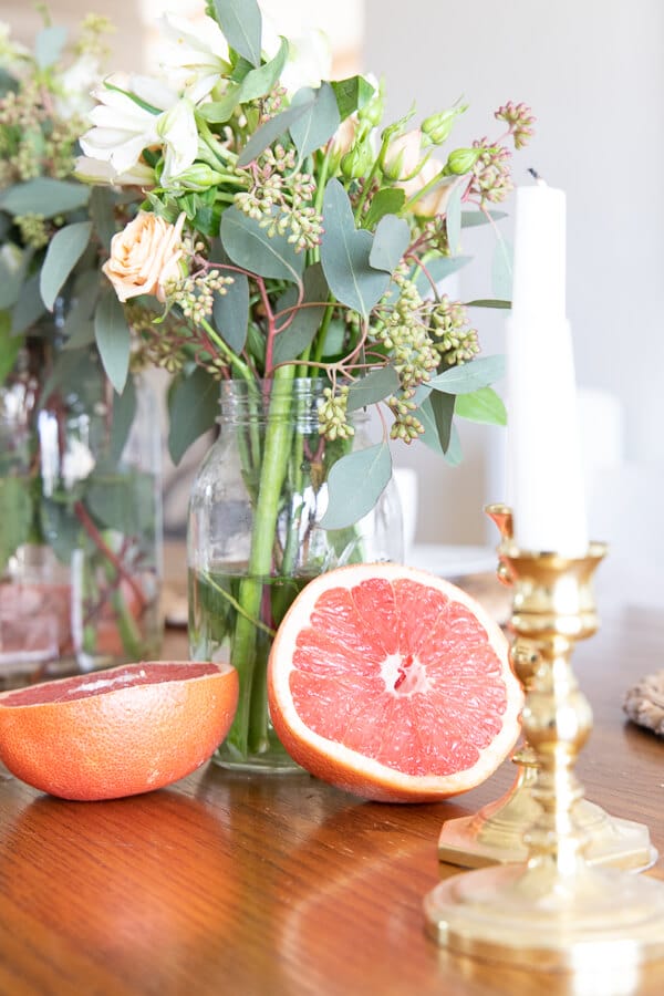 Spring tablescape ideas including fresh flowers, grapefruit, and other fresh fruits!