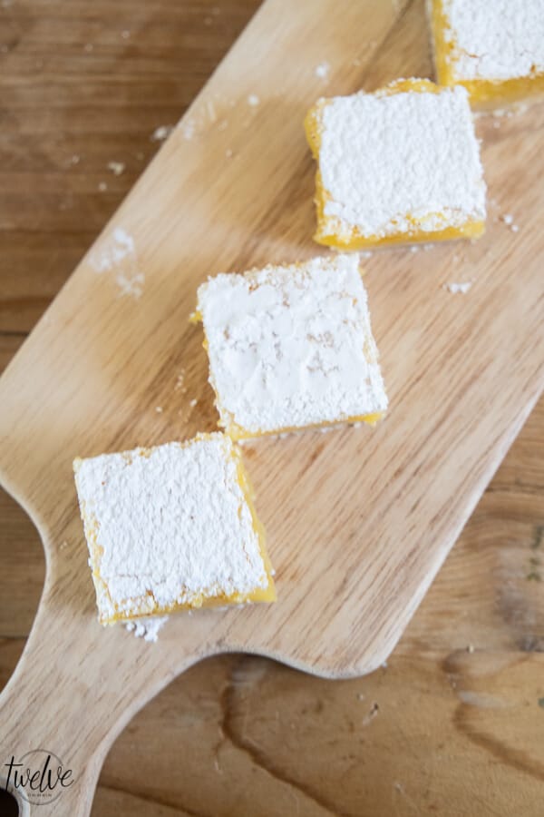 Sweet, tangy and gooey lemon bars. These are the most amazing lemons bars I have ever had! With a thick layer of lemon in the middle atop a tender crust and topped with powdered sugar, this treat is a hit! Eat them fresh, out of the fridge, or (our favorite) frozen!
