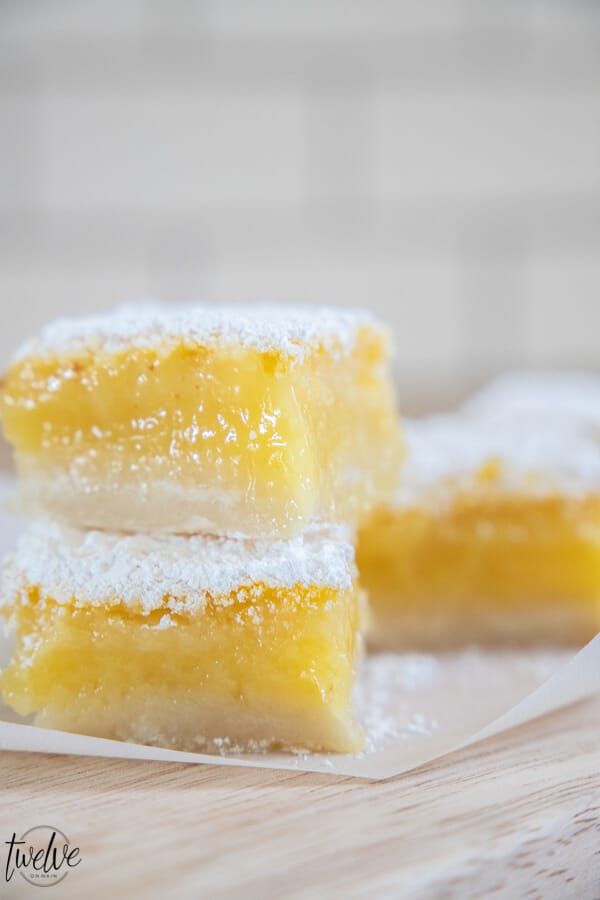 Sweet, tangy and gooey lemon bars. These are the most amazing lemons bars I have ever had! With a thick layer of lemon in the middle atop a tender crust and topped with powdered sugar, this treat is a hit! Eat them fresh, out of the fridge, or (our favorite) frozen!