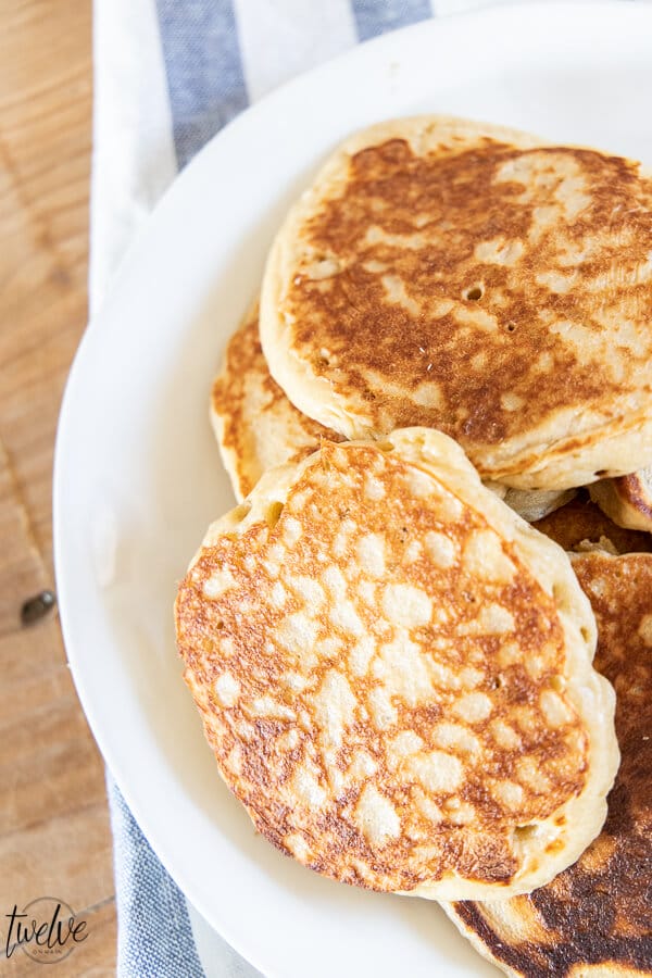 How to make light and fluffy whole wheat pancakes using your blender! These are the yummiest whole wheat pancakes, with a sweet nutty wheat flavor, and a light and fluffy texture.