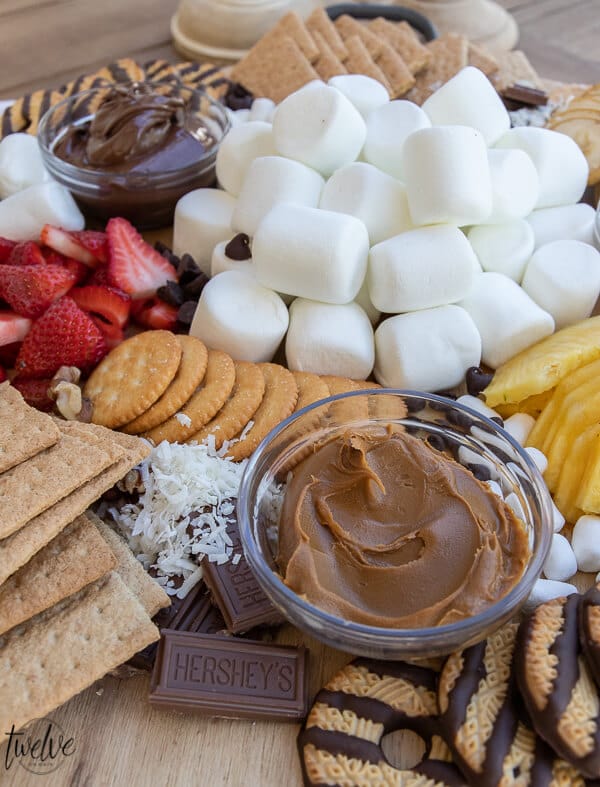 Make a fun s'mores board for that is perfect for entertaining a group or for simple night with the family. This s'mores bar gives everyone options and makes it easy to make any kind of s'mores you can dream of!