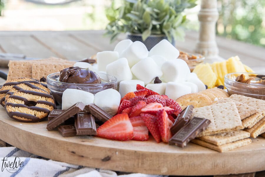 How to create a super simple and fun s'mores board that's perfect for a night our with family. I love to add marshmallows, fruits, crackers and cookies as well as peanut butter, Nutella and more!