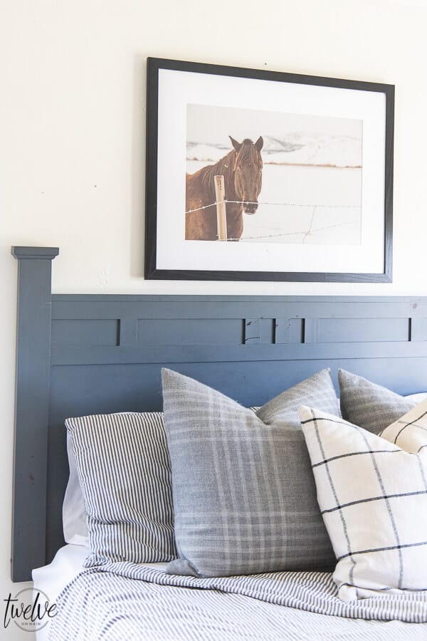 Teenage boys bedroom complete with simple white walls using Benjamin Moore Dove White, ticking strip bedding, grey plaid pillows and some horse photography to round it out.  