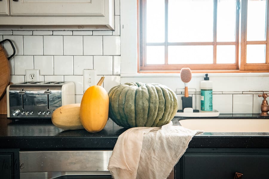 Fall kitchen decor using fresh harvest vegetables, and adding simple textures and deep fall colors to add warmth and coziness.